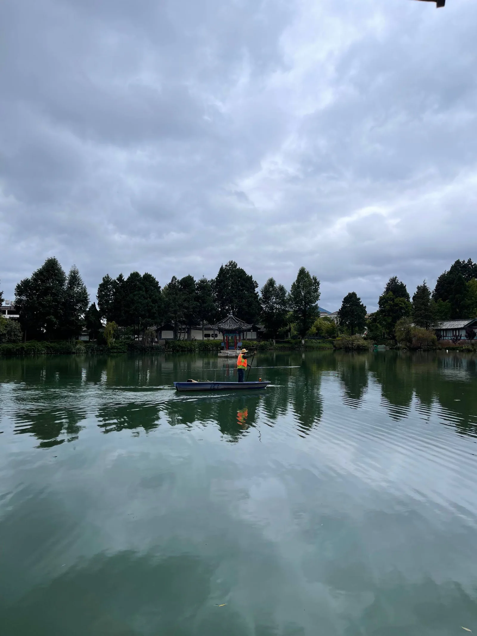 Documentary photograph of a boat crossing a lake in Yunnan
